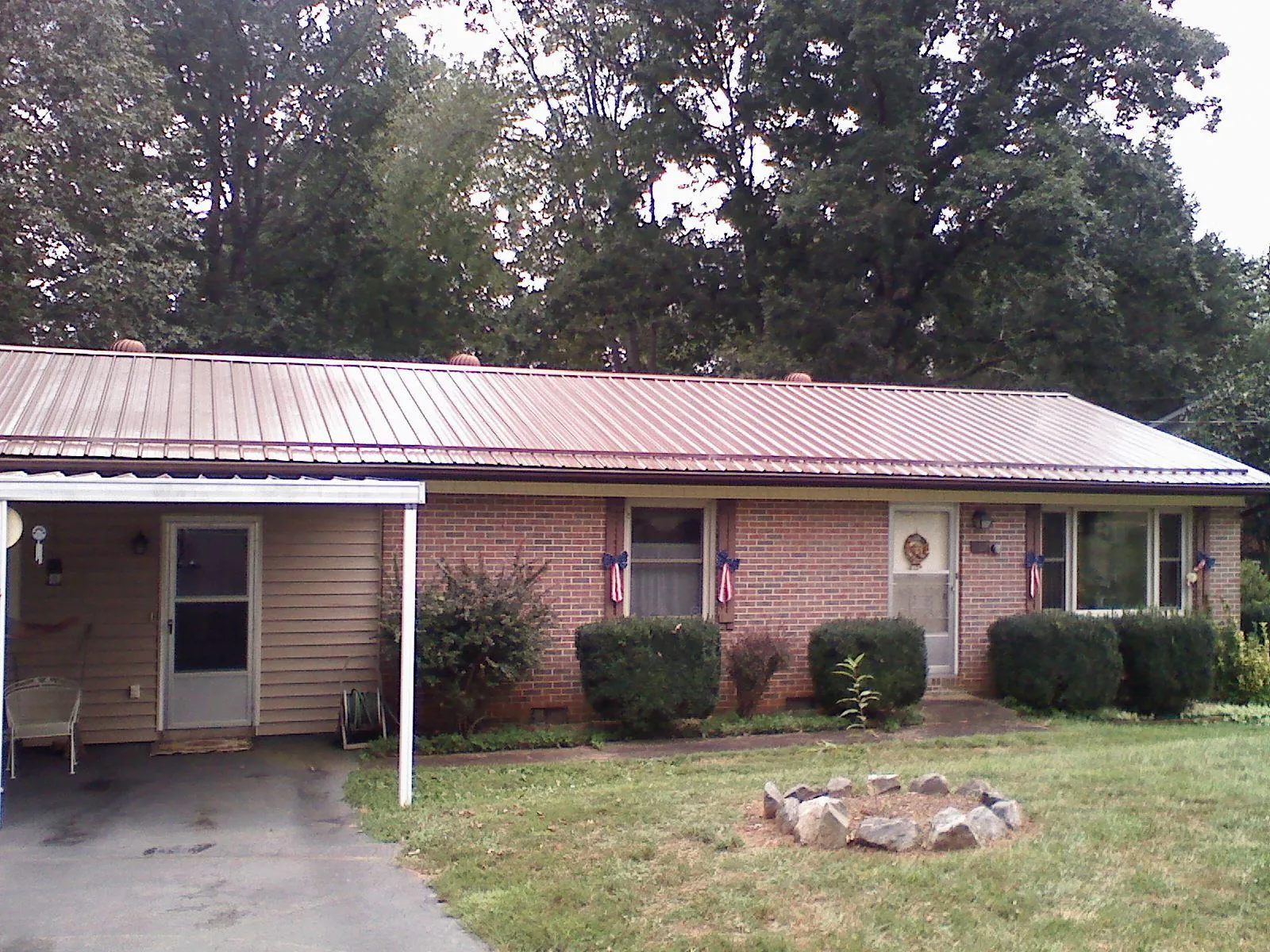 Bronze metal roof and carport on a brick ranch home — Roof Repair work by our crew in Asbury Park
